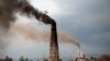 FILE - Smoke rises from the smokestacks of asphalt and brick factories burning coal, old shoes and oil extracted from tire rubber and plastic in Islamabad, Pakistan, March 9, 2017. 