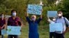 FILE - Members of a civil society group hold a demonstration demanding the government allow the construction of a Hindu temple, in Islamabad, Pakistan, July 8, 2020.