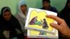 FILE - A counselor holds up cards used to educate women about female genital mutilation (FGM).