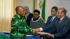 FILE - President John Magufuli, left, who seeks a second five-year term, hands over his electoral nomination form to Chairman of the National Electoral Commission (NEC) Judge Semistocles Kaijage, right, in Dodoma, Tanzania, Aug. 25, 2020. 