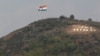 FILE - An Indian flag flies on a hill in the Uri sector, near the de facto border dividing Kashmir between India and Pakistan, in Indian-controlled Kashmir, Sept. 21, 2016. "Jai Hind" roughly translates into "Long live India."