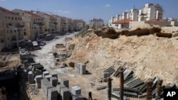 FILE- In this March 14, 2011, file photo, a general view of a construction site in the West Bank Jewish settlement of Modiin Illit. Israel approved the construction of 3,000 homes in Jewish settlements in the West Bank and east Jerusalem, a government of