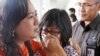 A relative of AirAsia flight QZ8501 passengers weeps as she waits for the latest news on the missing jetliner at Juanda International Airport in Surabaya, East Java, Indonesia, Dec. 28, 2014. 