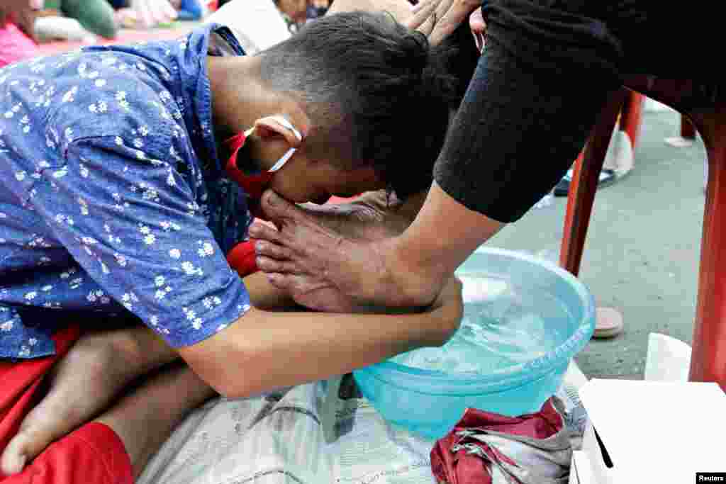 A child washes his mother&#39;s feet at an event to celebrate Indonesia&#39;s Mother&#39;s Day in Jakarta, Indonesia.