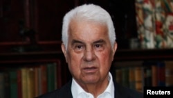 FILE - Turkish Cypriot leader Dervis Eroglu attends a photo call during a meeting with the leaders of the Greek and Turkish Cyprus communities at the Greentree estate in Manhasset, New York.