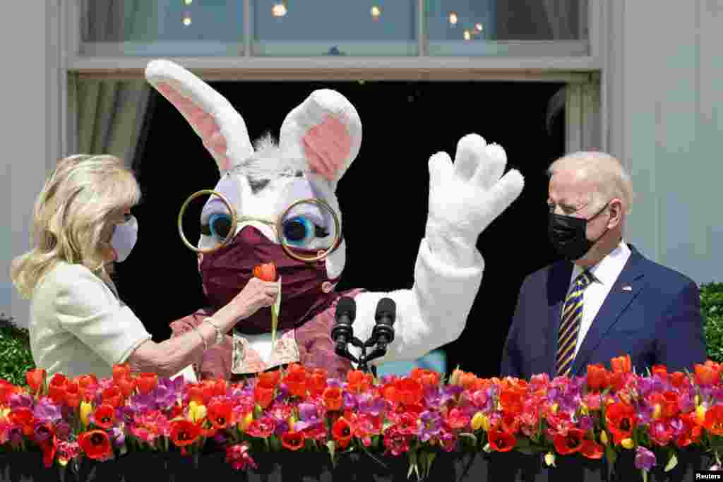 U.S. President Joe Biden,&nbsp;first lady Jill Biden and a person wearing an Easter Bunny costume are see on the Blue Room Balcony of the White House in Washington.