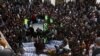 People and family members gather to identify the bodies of their relatives, who were coal miners from Pakistan's minority Shi'ite Hazara community and got killed by unidentifyed persons in Mach area of Bolan district, in Quetta, Pakistan, Jan, 3, 2021.