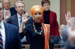FILE - In this Jan. 3, 2017, file photo, State Rep. Ilhan Omar takes the oath of office as the 2017 Legislature convened in St. Paul, Minn.