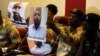 Photographs of Rufai Abubakar Tsiga (L) and Aminu Sadiq Ogwuchem are presented to the media by the State Security Service in Abuja, Nigeria, May 12, 2014.
