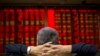 FILE - A Chinese investor monitors stock prices at a brokerage house in Beijing, Sept. 16, 2015.