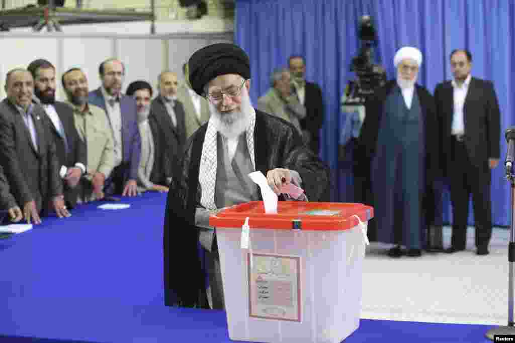 Iran's Supreme Leader Ayatollah Ali Khamenei casts his ballot at his office during the Iranian presidential election in central Tehran, June 14, 2013.