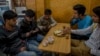 Kashmiri students browse the internet on their mobile phones as they sits inside a restaurant in Srinagar, Indian controlled Kashmir, April 26, 2017. On Wednesday, authorities ordered internet service providers to block 16 social media sites, including Facebook and Twitter, and popular online chat applications for one month "in the interest of maintenance of public order." 