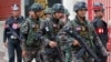 FILE - Soldiers patrol around the Royal Thai Army Headquarters as members of the Radio and Satellite Broadcasters gather in Bangkok, June 18, 2014. 