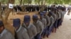 Zimbabwean police officers wait in line to cast their votes at a polling station in Harare, July 15, 2013. Early voting started for police and security personnel who will be on duty during the nation's July 31elections. 