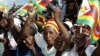 FILE - Zimbabwe political supporters wave flags in Gutu, a rural town 220 Km's southeast of the capital Harare.