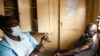 FILE - In this March 29, 2021 file photo, a man prepares for his AstraZeneca COVID-19 vaccine at Ndirande Health Center in Blantyre, Malawi.