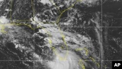 This Saturday, Sept. 12, 2020 image provided by NOAA shows the formation of Tropical Storm Sally. The storm is expected to reach hurricane strength, Sept. 14, 2020 as it approaches the U.S. Gulf Coast.