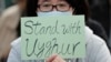 A man holds a sign during a rally to show support for Uighurs and their fight for human rights in Hong Kong, Dec. 22, 2019.