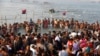 Indian Hindu devotees gather to take holy dips at Sangam, the confluence of the Rivers Ganges, Yamuna and mythical Saraswati on Maghi Purnima, or the full-moon day of the month during the annual "Magh Mela" fair in Allahabad, Feb. 10, 2017.