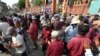 Three-wheeled pedicab drivers sanitize their hands with alcohol while waiting for customers in Phnom Penh, Cambodia, Friday, March 27, 2020. (AP Photo/Heng Sinith)