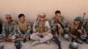 FILE - A U.S. Marine(C) talks with Afghan National Army soldiers during a training in Helmand province, Afghanistan, July 5, 2017.