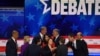 Democratic presidential hopefuls, left to right, Cory Booker, Elizabeth Warren, Julian Castro, Bill de Blasio, Tulsi Gabbard, Amy Klobuchar, Jay Inslee, moderator Chuck Todd, Beto O’Rourke and John Delaney greet each other after the debate. 