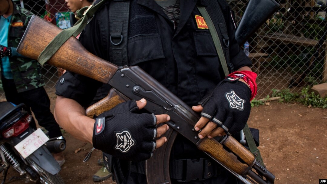 This photo taken on October 19, 2021 shows members of the Karenni Nationalities Defense Force and Kareni Army at a checkpoint near Demoso, in Myanmar's eastern Kayah state.