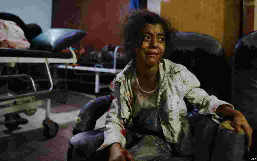 A wounded Syrian girl cries at a make-shift hospital in the rebel-held area of Douma, east of the capital Damascus, following reported air strikes by regime forces, Aug. 12, 2015.
