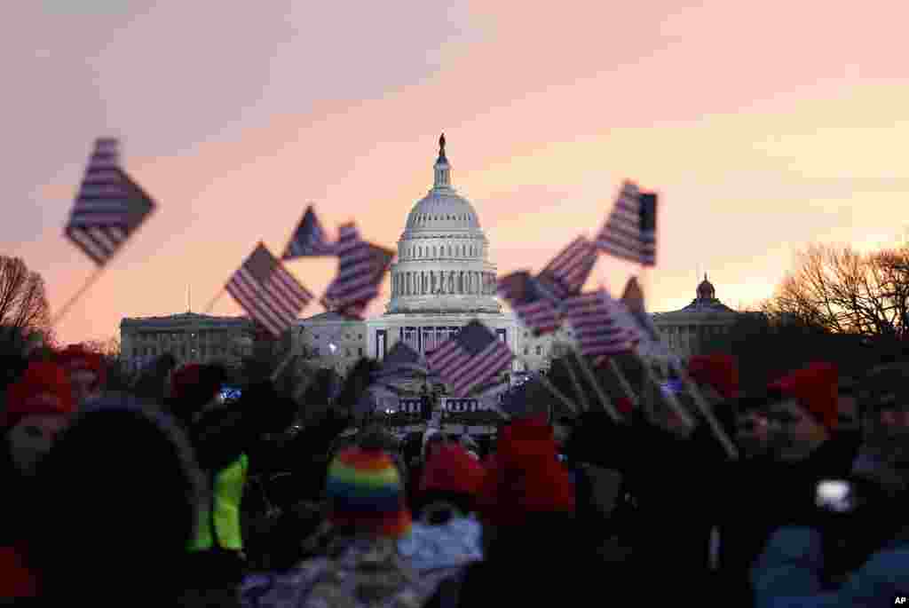 President Barack Obama supporters wave American flags on the National Mall in Washington, Jan. 21, 2013, prior to the start of the president's ceremonial swearing-in ceremony during the 57th Presidential Inauguration.