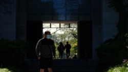 FILE - Students make their way through the University of Chicago campus, in Chicago, May 6, 2021.