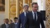 British Prime Minister Cameron, followed by U.S. Secretary of State John Kerry, arrives to open the international anti-corruption summit on May 12, 2016 in London, England. 