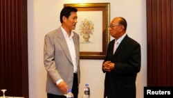 Secretary-General of Thailand's National Security Council Paradorn Pattanathabutr (L) speaks to Chairman of the Advisory Council for Peace Building in the Southern Border Provinces Aziz Benhawan, before a meeting ahead of talks with Thailand's Nation