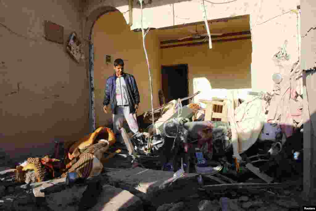 A boy surveys the site of a car bomb attack in Kirkuk, north of Baghdad, Jan. 20, 2014. 