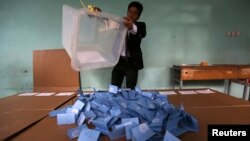 An Afghan election official empties a ballot box for counting at the end of polling in Herat Province, Apr. 5, 2014. 