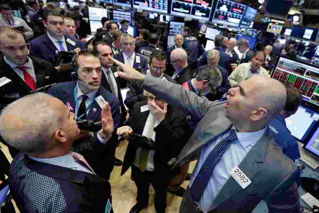 Specialist Philip Finale, right, directs trading in LinkedIn on the floor of the New York Stock Exchange. Microsoft said Monday that it is buying professional networking service site LinkedIn for about $26.2 billion.