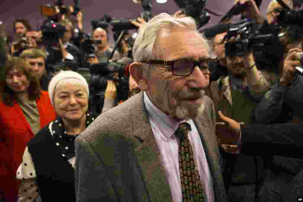 The parents of Mikhail Khodorkovsky, his father Boris, right, and his mother Marina, center left, arrive at their son's news conference in Berlin, Germany, Dec. 22, 2013.