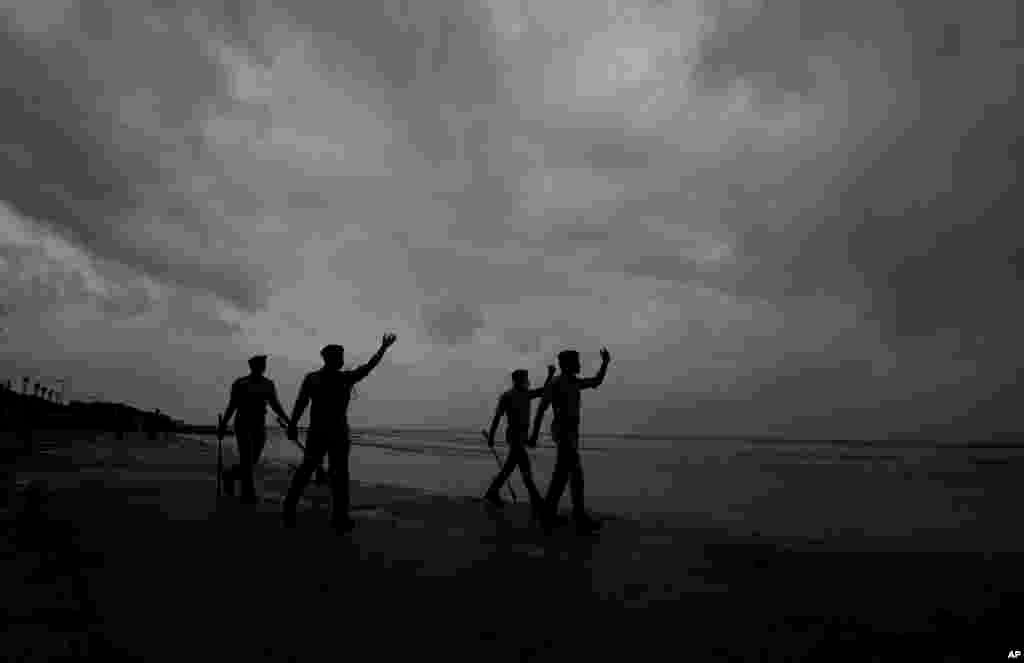 Policemen ask people to move to cyclone shelters as they patrol a beach in Balasore district in Odisha, India. Tens of thousands of people were evacuated in low-lying areas of two Indian states to escape from a powerful storm barreling toward the eastern coast.&nbsp;