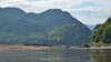 A yellow flag along the Mekong River marks the spot chosen for construction of the Luang Prabang dam near Houaygno village, Laos, Nov. 4, 2019. (Zsombor Peter/VOA)