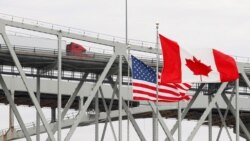 A truck crosses the Blue Water Bridge into Port Huron, Mich., from Sarnia, Ontario, Canada, March 18, 2020.