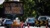 A COVID-19 signage is seen at a vehicle checkpoint on the Pacific Highway on the Queensland - New South Wales border in Brisbane on April 15, 2020. 
