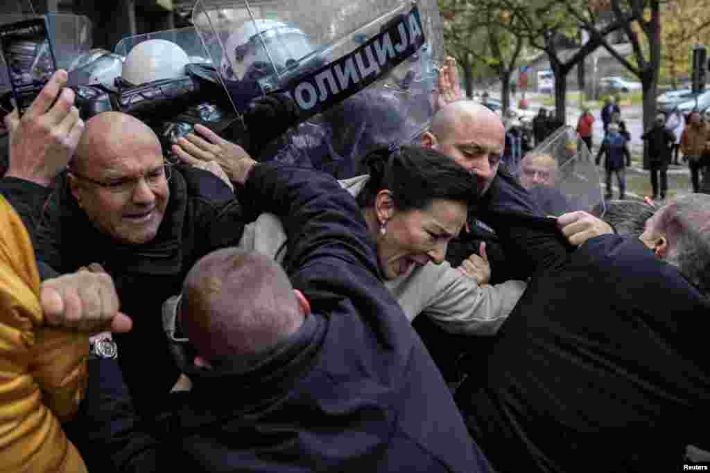 Serbian members of parliament Marinika Tepic and Borislav Novakovic, and other opposition representatives scuffle with police officers during a protest over the fatal collapse of a roof at a railway station, demanding that those responsible for the disaster be brought to justice, in front of a court house in Novi Sad.&nbsp;