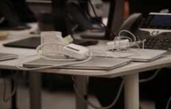 FILE - Laptops sit on a table in the empty offices of Cambridge Analytica in Washington, D.C., U.S., May 2, 2018.