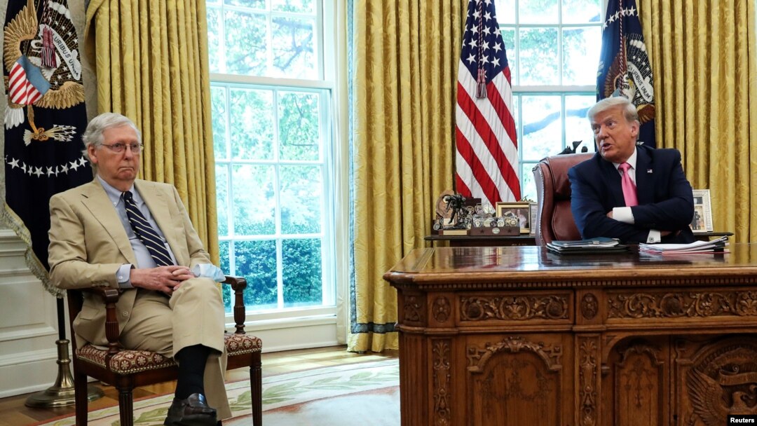 U.S. President Donald Trump speaks about legislation for additional coronavirus aid as U.S. Senate Majority Leader Mitch McConnell (R-KY) listens in the Oval Office at the White House in Washington, July 20, 2020. 