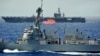 FILE - The USS Chung-Hoon guided-missile destroyer, front, and the USS Nimitz aircraft carrier are underway during the Great Green Fleet demonstration portion of the Rim of the Pacific (RIMPAC) 2012 exercise, July 18, 2012.