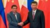 FILE - Philippine President Rodrigo Duterte, left, and Chinese President Xi Jinping pose for photographers on the sidelines of the Belt and Road Forum for International Cooperation at the Great Hall of the People in Beijing, May 15, 2017. 