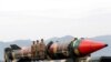 FILE - Pakistani military personnel stand beside a Shaheen III surface-to-surface ballistic missile during a Pakistan Day military parade in Islamabad, March 23, 2019. 