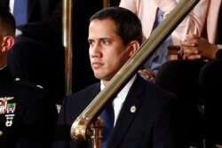 Venezuelan opposition leader Juan Guaido listens as President Donald Trump delivers his State of the Union address to a joint session of Congress on Capitol Hill in Washington, Feb. 4, 2020.