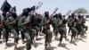 FILE - Al-Shabab fighters march during military exercises in the Lafofe area, some 18 kilometers (11 miles) south of Mogadishu, Somalia, Feb. 17, 2011.