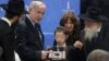 Prime Minister Netanyahu receives a memento from a young boy whose parents were killed during a terror attack as he unveils plans for a state-of-the-art Living Memorial in commemoration of the victims of the Mumbai attacks at the Chabad House in Mumbai, Jan. 18, 2018.