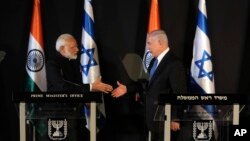 Indian Prime Minister Narendra Modi, left, shakes hands with Israeli Prime Minister Benjamin Netanyahu during their meeting at the King David hotel in Jerusalem, July 5, 2017. 